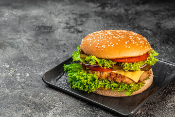 Homemade hamburger with beef, tomato, cheese, and lettuce