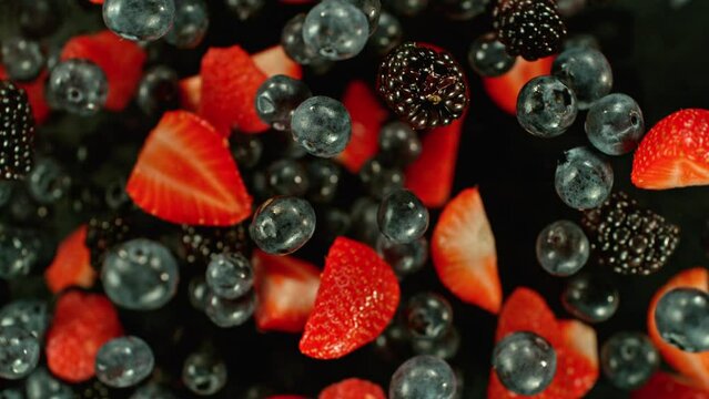 Super slow motion of rotating berries in the air, top view. Filmed on high speed cinema camera, 1000 fps.