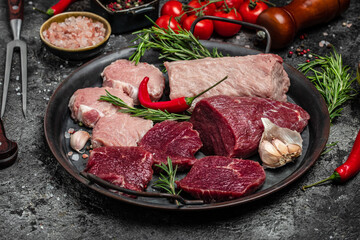 raw pork meat and beef with rosemary and spices on a wooden board. Restaurant menu, dieting, cookbook recipe. place for text