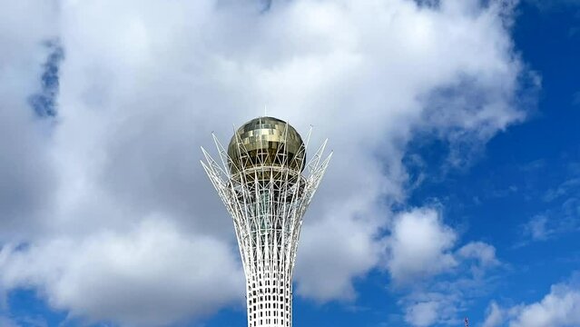 Astana, Kazakhstan, April 2023. Baiterek against a blue sky with clouds. Time lapse vertical video.