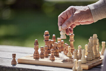 Make moves that matter. Shot of an unrecognisable senior man playing a game of chess outside.