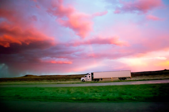 Semi 18 Wheel Diesel Truck At Dusk Sunset With Storm