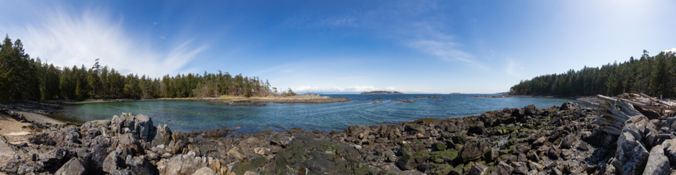 Rocky Shore on West Coast of Pacific Ocean in Nanoose Bay. Vancouver Island, British Columbia, Canada. Sunny Sky. Canadian Nature Panorama Background