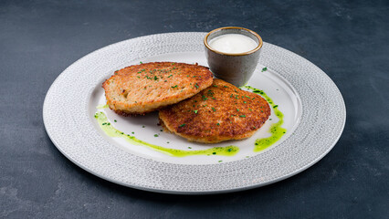 Hot fried potato pancakes with sour cream.
