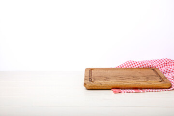 Cutting board with napkin on wooden table with isolated background.Handmade cutting board wood cutting board. Wooden board on a white background. MOCKUP. Design.