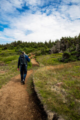 Man walking away on mountain path