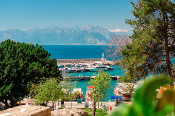 Naklejka premium Aerial view of the port and the lighthouse in the Turkish city of Antalya. View of the port from Kaleici in Antalya.