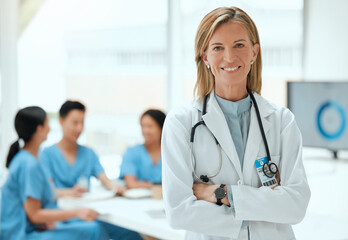 Weve got the best healthcare in town. Shot of a mature female doctor standing with her arms crossed at a hospital.