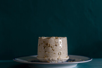 Fresh Alentejo goat cheese with herbs and salt on a plate.