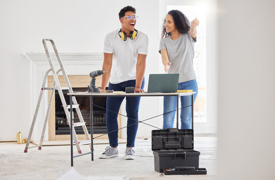 Renovating a house is a no brainer for people who like a challenge. Shot of a young couple using a laptop while busy renovating a house.
