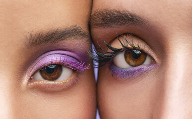 Look us in the eye and say you dont like purple. Cropped shot of two young women wearing purple make-up.