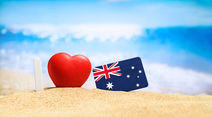 I love Australia. Flag of Australia on the beach with a red heart. vacation and travel concept.