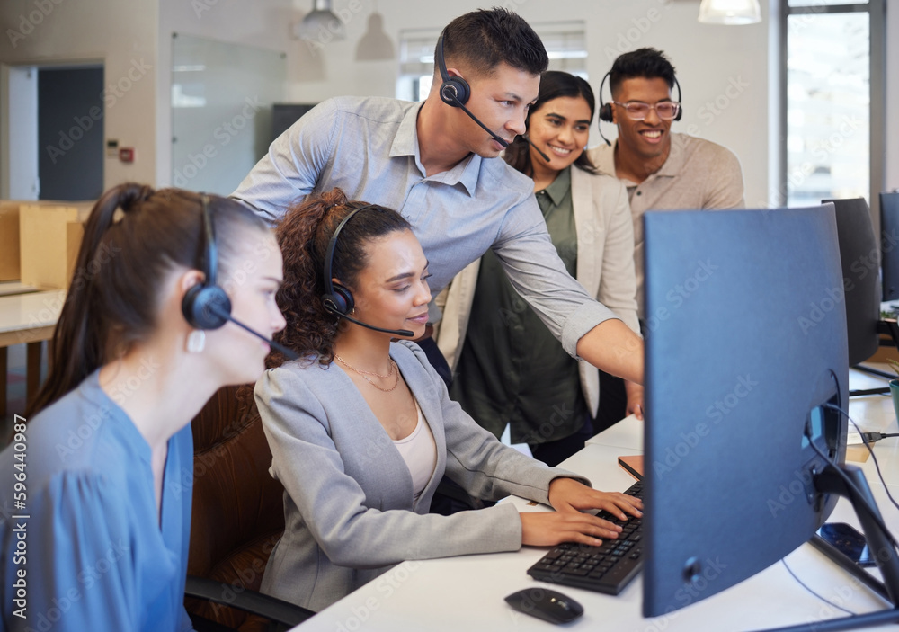 Fototapete The whole team are on it especially for you. Shot of a group of call centre agents working together on a computer in an office.