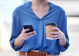 Both are sources of fuel. Shot of a businesswoman drinking a cup coffee while using her smartphone.