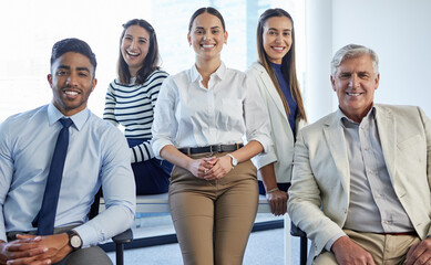 Their services come highly recommended. Shot of a group of businesspeople posing together in an office.