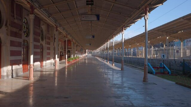 Early morning at the empty railway station. Action. Sunshine on the empty platform.