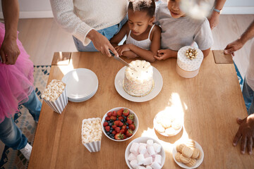 Natures way of telling us to eat more cake. Shot of a family preparing to eat a cake at a birthday party at home.