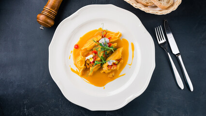 Italian Ravioli with shrimp, pear, sauce and microgreens.