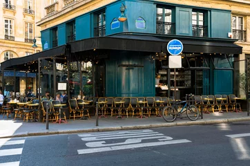 Papier Peint photo Lavable Vélo Cozy street with tables of cafe  in Paris, France. Cityscape of Paris. Architecture and landmarks of Paris