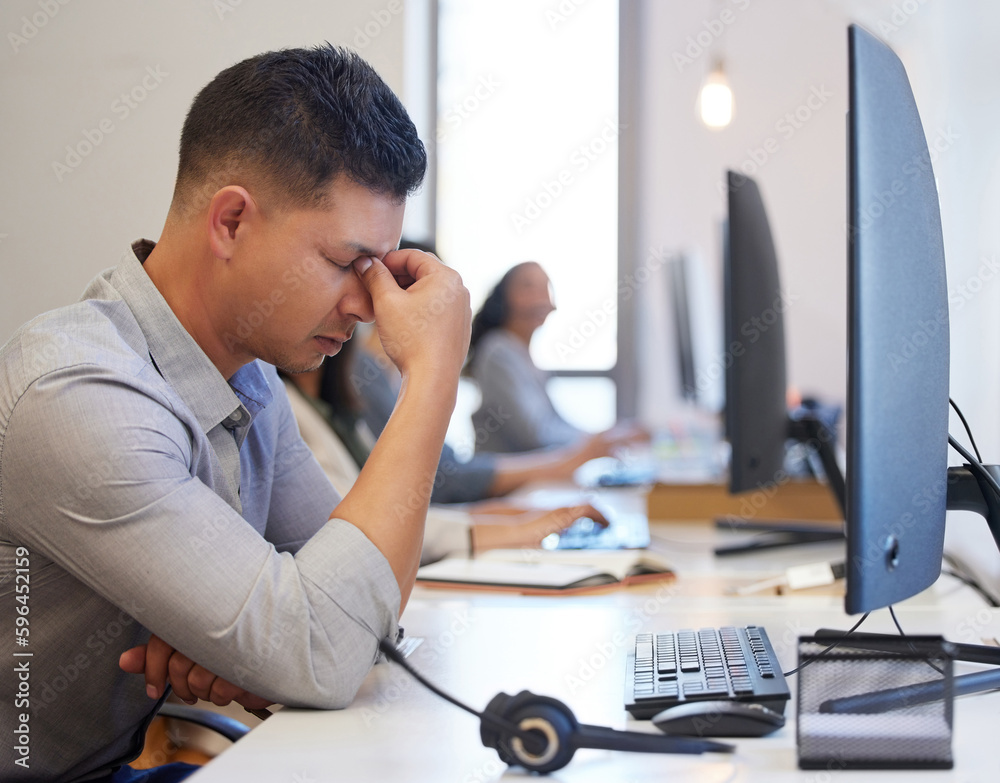 Poster give me a break. shot of a young call centre agent looking stressed out while working in an office.