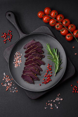 Delicious dried smoked beef or horse meat jerky with spices and salt