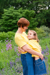 Happy mother's day, children's day or birthday. Happy mother and daughter hugging in the park.