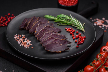 Delicious dried smoked beef or horse meat jerky with spices and salt