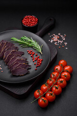 Delicious dried smoked beef or horse meat jerky with spices and salt