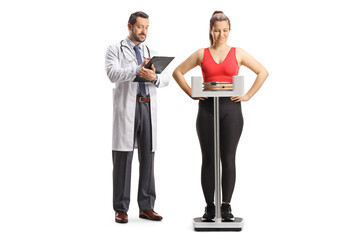 Young woman in sportswear weighing on a medical scale and male doctor writing a document
