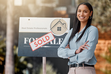 Proud, confident, always on call. Shot of a real estate agent standing next to a sold sign outside.