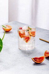 Cold refreshing summer drink with red oranges and thyme