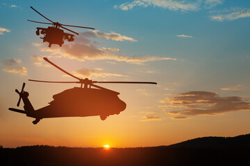Obraz na płótnie Canvas Silhouettes of helicopters on background of sunset. Greeting card for Veterans Day, Memorial Day, Air Force Day. USA celebration.