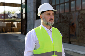Portrait of professional industrial engineer caucasian man wearing helmet and goggles in manufacturing industry. Technology and innovation concept.