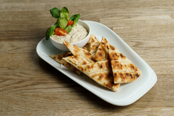 Feta cheese dip with dill, greek pita bread on the side