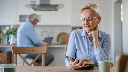 Fototapeta na wymiar Senior woman mature caucasian female read book at home wear eyeglasses