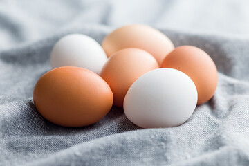 Whole chicken eggs on kitchen napkin.