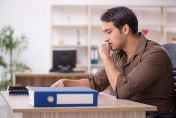 Young attractive employee sitting in the office