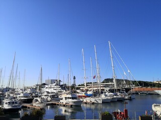 Fototapeta na wymiar Yachts and boats parked in the marina summer blue sky, Lanzarote, Canary Islands, Spain