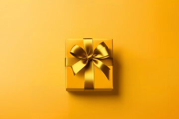 Gift box with golden satin ribbon and bow on yellow background. Holiday gift with copy space. Birthday or Christmas present, top view. Generative AI