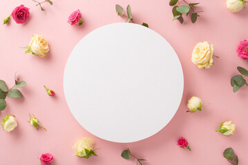 Tenderness concept. Top view flat lay of eucalyptus leaves with rose flowers on pastel pink background with empty circle for text or branding