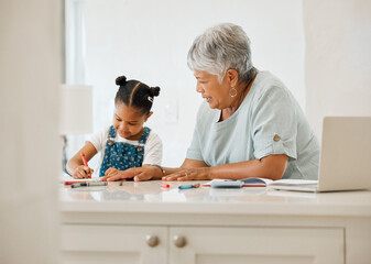 Obraz premium Can I draw too. Shot of a grandma helping her granddaughter at the kitchen table at home.