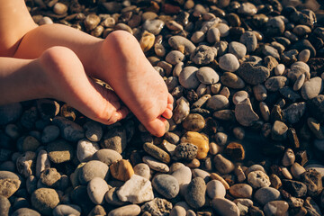 Little child's bare feet  on the beach