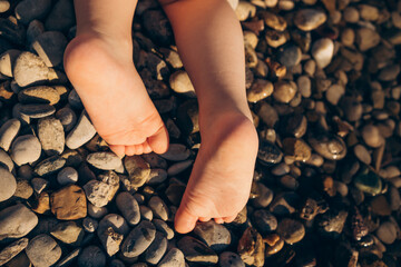 Little child's bare feet  on the beach