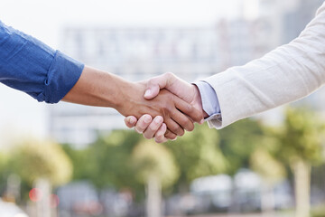 If you want to go far, go together. Shot of two unrecognizable businesspeople shaking hands.