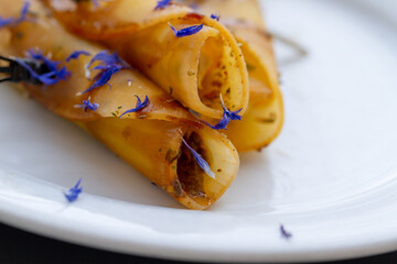 tender baked dough rolls sprinkled with edible flowers as an appetizer
