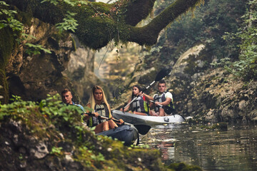 A group of friends enjoying having fun and kayaking while exploring the calm river, surrounding forest and large natural river canyons