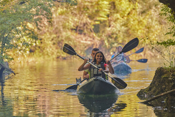 A group of friends enjoying having fun and kayaking while exploring the calm river, surrounding forest and large natural river canyons