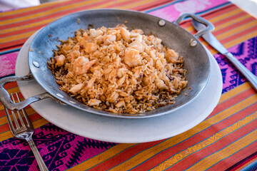 rice with shrimp on a metal pan and accompaniment from the Colombian tropics