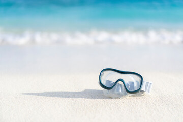 Diving goggles on an empty beach in the Maldives