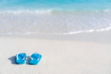 Flip flops on the beach on the background of ocean in the Maldives. Beach vacation - Powered by Adobe